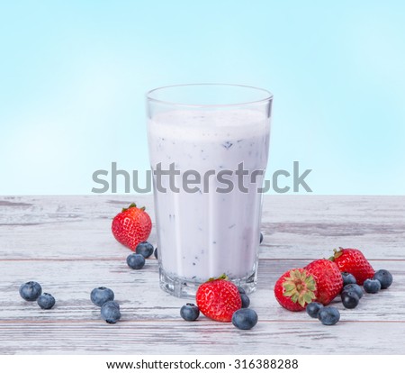Fresh milk, blueberry drink on wooden table, assorted protein cocktail with fresh fruits.