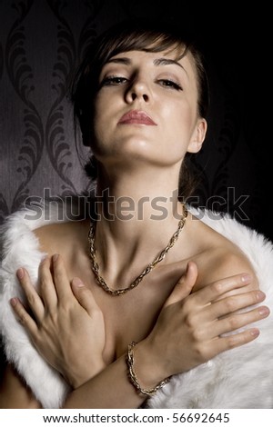 portrait of attractive woman wearing necklace over wallpaper background