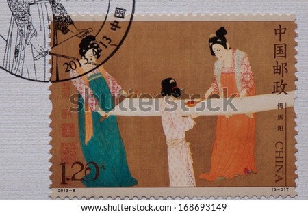 CHINA - CIRCA 2013:A stamp printed in China shows image of Chinese ancient painting - Court Ladies Preparing Newly Wove Silk,circa 2013