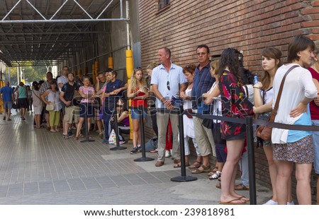 BARCELONA, SPAIN-SEPTEMBER 18: Long queue of people for ticket to La Sagrada Familia - designed by Gaudi, which is being build in1882 and is not finished yet September 18, 2014 in Barcelona, Spain.