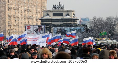 MOSCOW, RUSSIA, FEBRUARY 04 - The citizens go to the meeting for supporting of Vladimir Putin with russian three-colors flags on February 04, 2012 in Moscow
