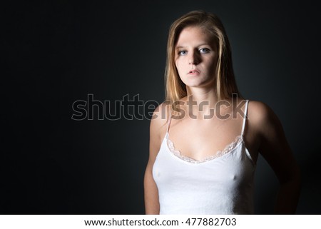 Portrait Of An Attractive Blond Woman Wearing A White Nightshirt In Front Of Black Studio Portrait Of An Attractive Blond Woman Wearing A White Nightshirt In Front Of Black Studio