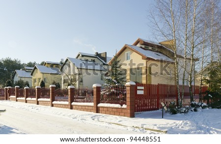 Modern European mass rural building village landscape, solar winter day