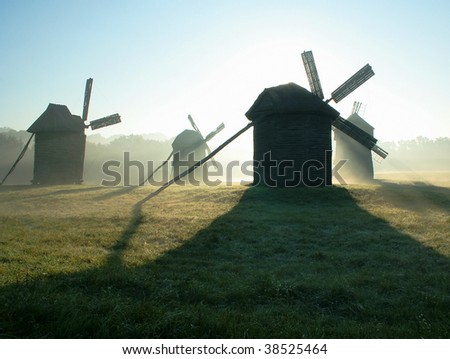 Morning, fog, sunrise, silhouettes of wind-driven generators
