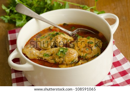 Slow-cooked chicken paprika in a cooking pot