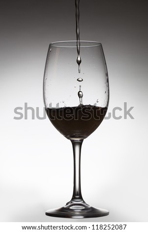 Pouring drink and transparent glass.