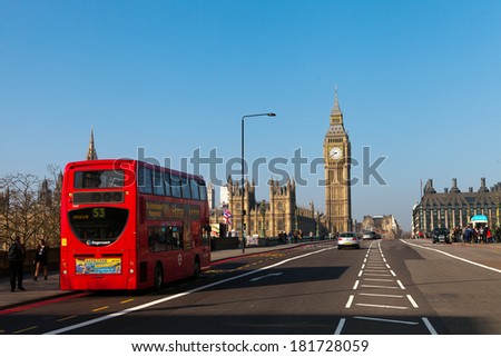LONDON -  MARCH 9. Iconic London bus crossing Westminster Bridge in the United Kingdom March 9, 2014 in London, England.