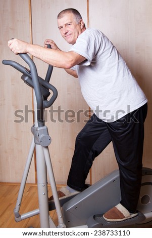 Man exercising on step machine.