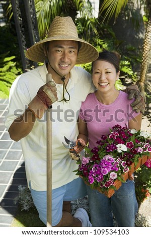 Portrait of a happy mature couple gardening together