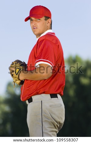 Young baseball pitcher holding mitt