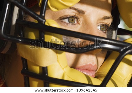 Closeup of a female softball player with helmet