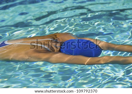 Female participant swimming underwater in pool