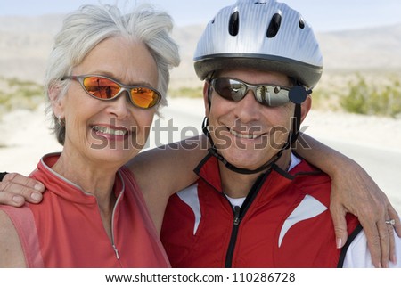 Happy senior couple in sports uniform