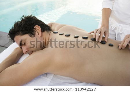 Man receiving hot stone massage