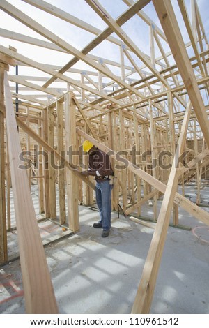 African american man measuring form work at construction site