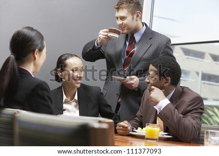 Business team having a coffee break during their meeting at office
