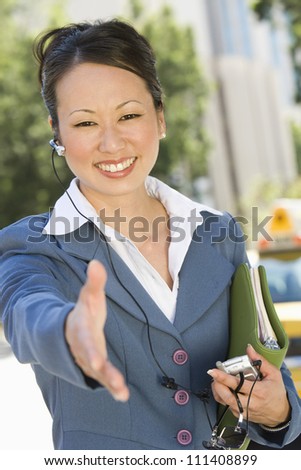 Happy business woman with open hand ready for a deal