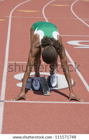 African American female athlete ready to start race