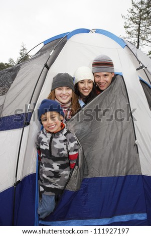 Happy family camping together in the tent