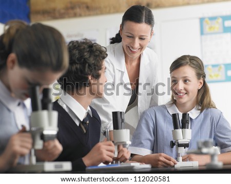 Group of students in discussion with teacher in laboratory