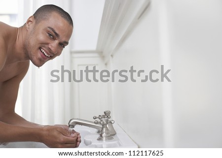 Man washing face in sink