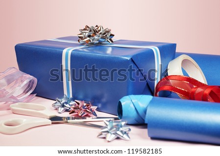 Gift packing materials isolated over pink background