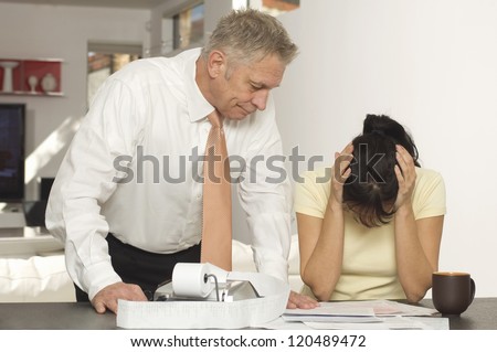 Unhappy woman with senior financial adviser in office