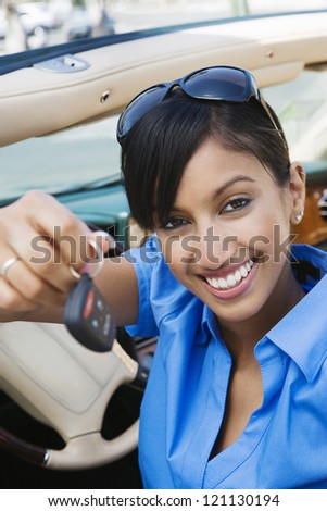 Portrait of a happy young Indian business woman showing new car keys