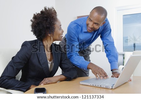 Happy African American business people looking at each other and smiling