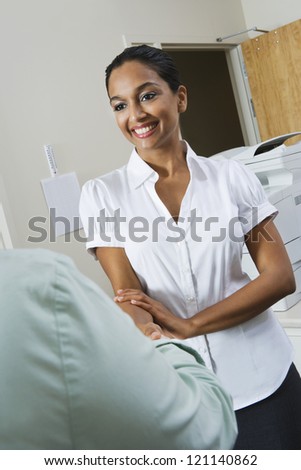 Happy Indian business woman welcoming coworker in office