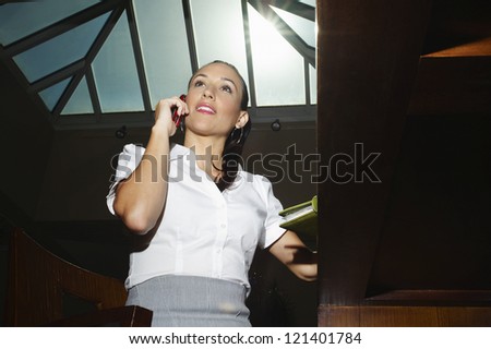 Low angle view of a business woman talking on cell phone
