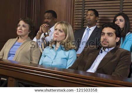 Group of business people sitting together in witness stand of court house