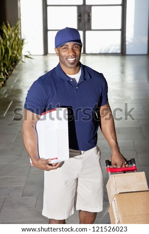 Happy delivery man with packages