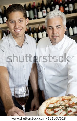 Portrait of happy men with wine glass and pizza