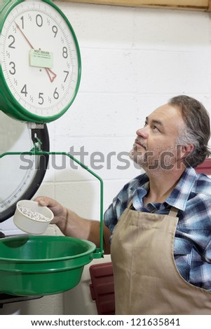 Middle-aged man looking up at weight scale