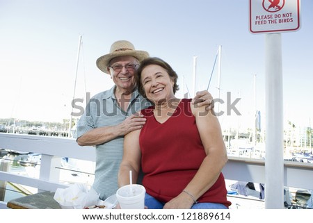 Happy senior Caucasian couple spending leisure time in an open restaurant