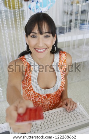 Female employee giving credit card