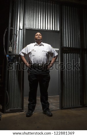 Security guard standing with hands on hips