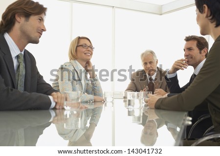 Smiling business colleagues having a discussion in conference room