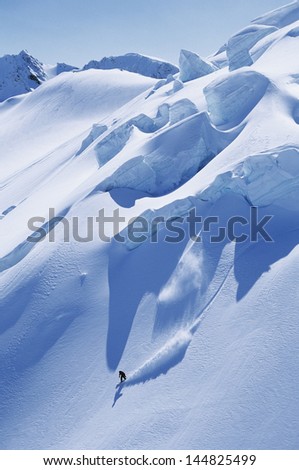 High angle view of man snowboarding on steep slope