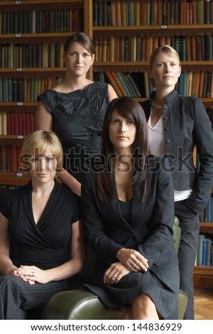 Portrait of confident female lawyers standing together in library