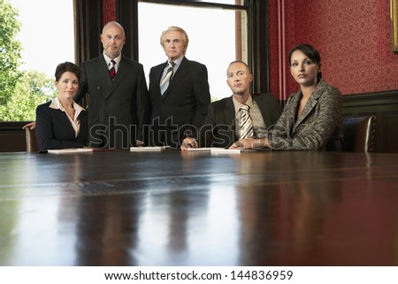 Portrait of serious multiethnic business team at conference table