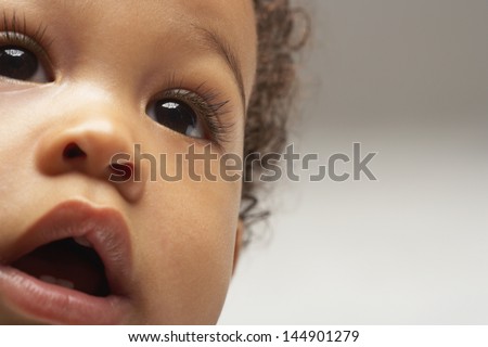 Closeup of African American curious baby boy looking away