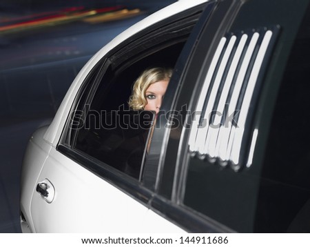 Portrait of beautiful female celebrity inside the limo car