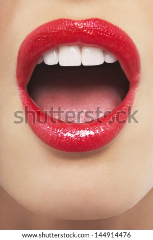 Full frame image of surprised woman with red lips