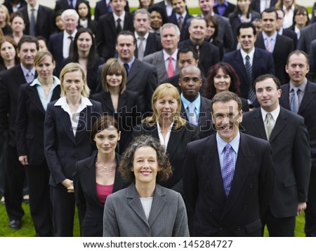 Portrait of a confident businesswoman with multiethnic team