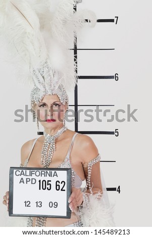 Mug shot of senior showgirl holding plaque