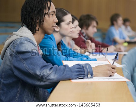 Side view of a group of multiethnic students in lecture room