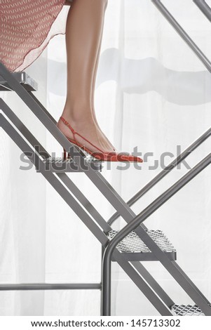 Low section of woman wearing high heels on steps