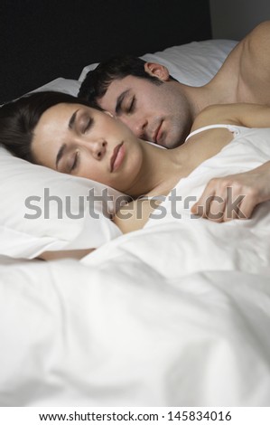 Young couple fast asleep in bed